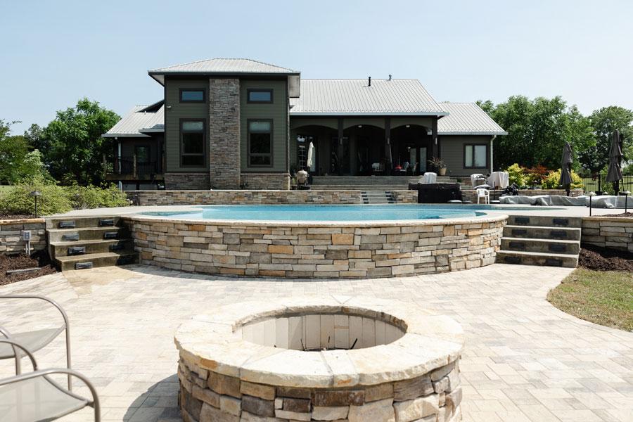 Luxury backyard with pool and stone fire pit in Metro Atlanta