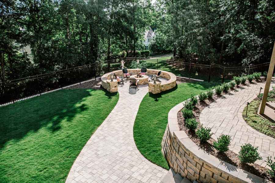 Backyard fire pit with stone seating and paver walkway in Metro Atlanta