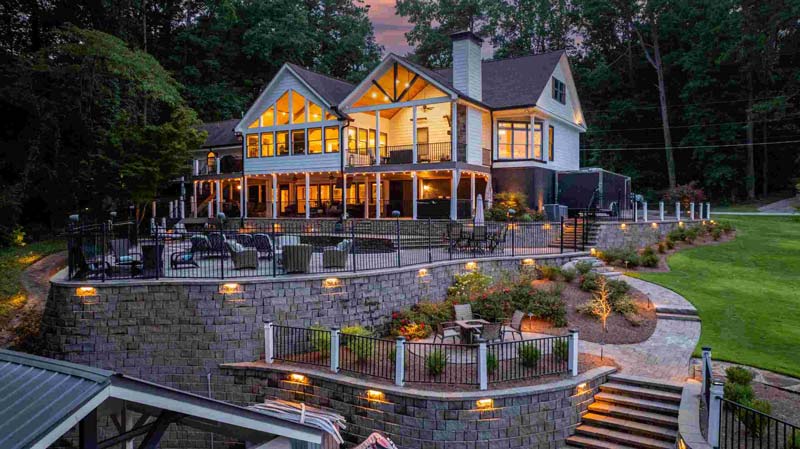Multi-tiered landscape lighting and retaining walls by A Abby Group in Metro Atlanta.