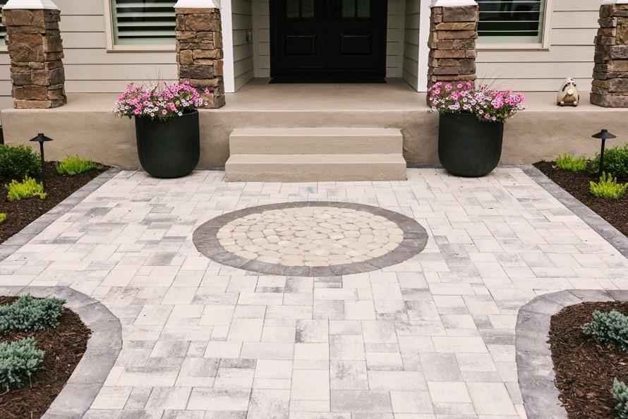 Front porch with stone paver walkway and flower planters in Metro Atlanta