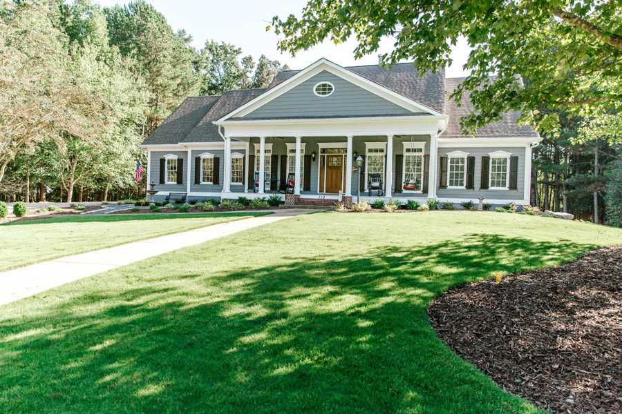 Large house with a front porch and green lawn in Metro Atlanta