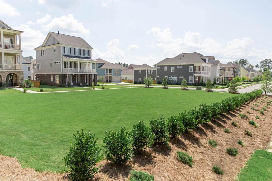 Suburban neighborhood with large green lawn and houses in Metro Atlanta