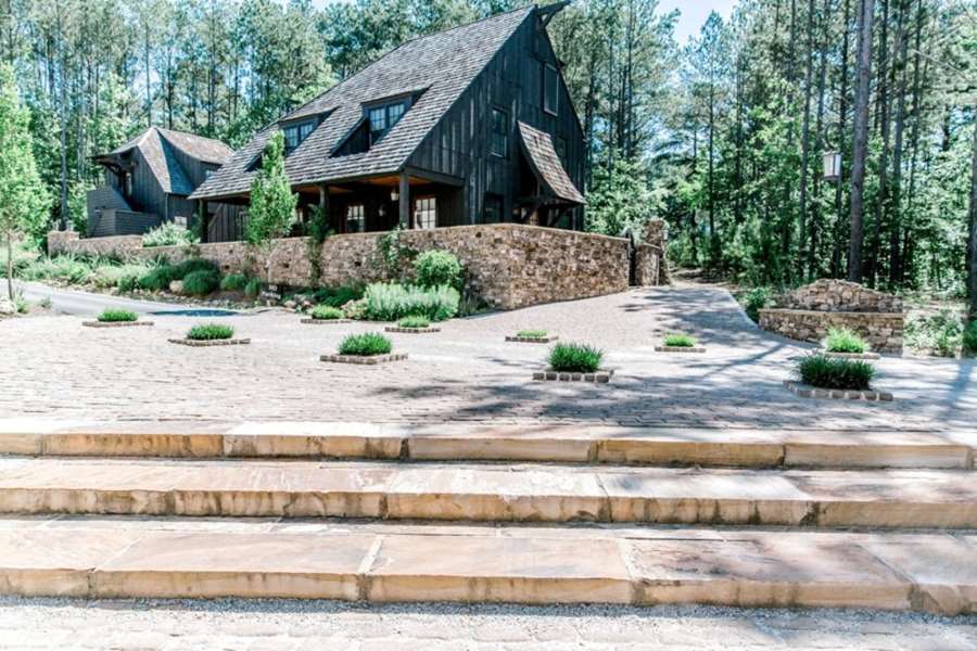 Rustic home with stone landscaping and tiered steps surrounded by trees in Metro Atlanta